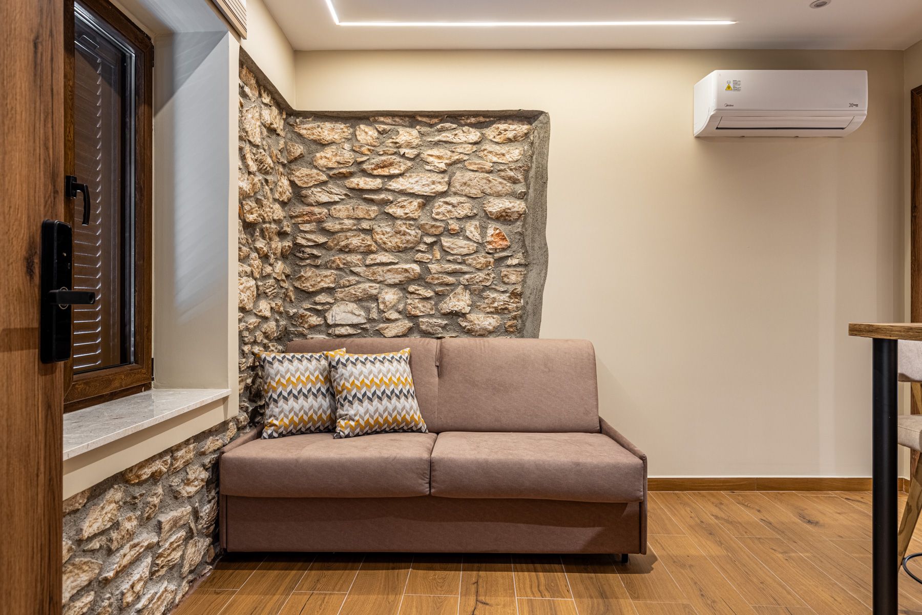 The two-seat sofa in Anemoessa, set into an alcove of the original stone