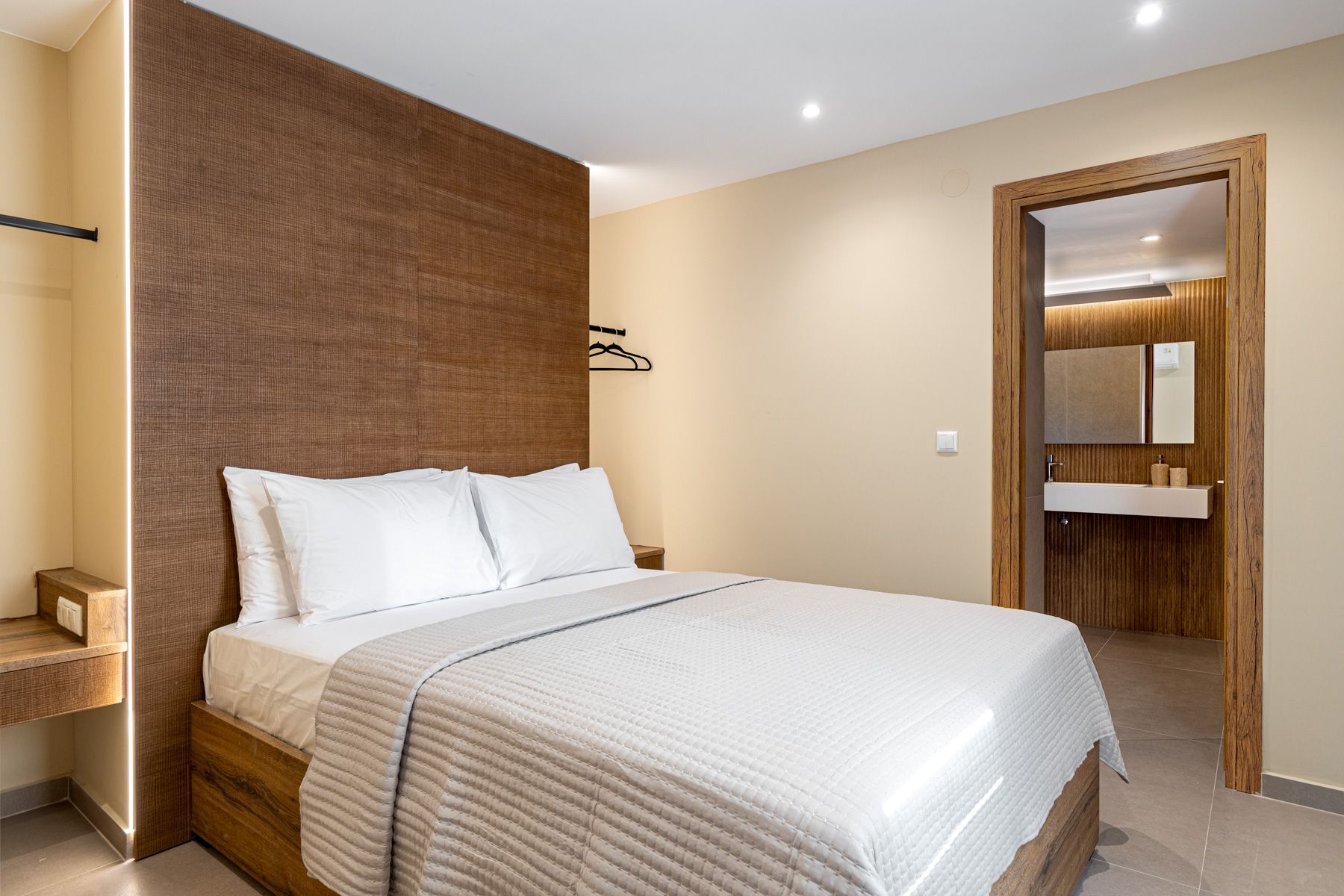 The bedroom in Asteroessa, with the bathroom door open beyond