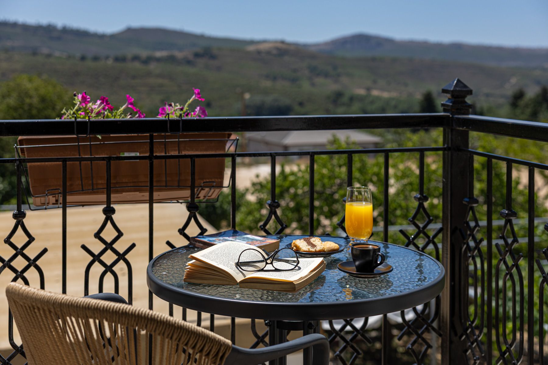 Breakfast laid on the balcony table in Asteroessa, with the hills beyond