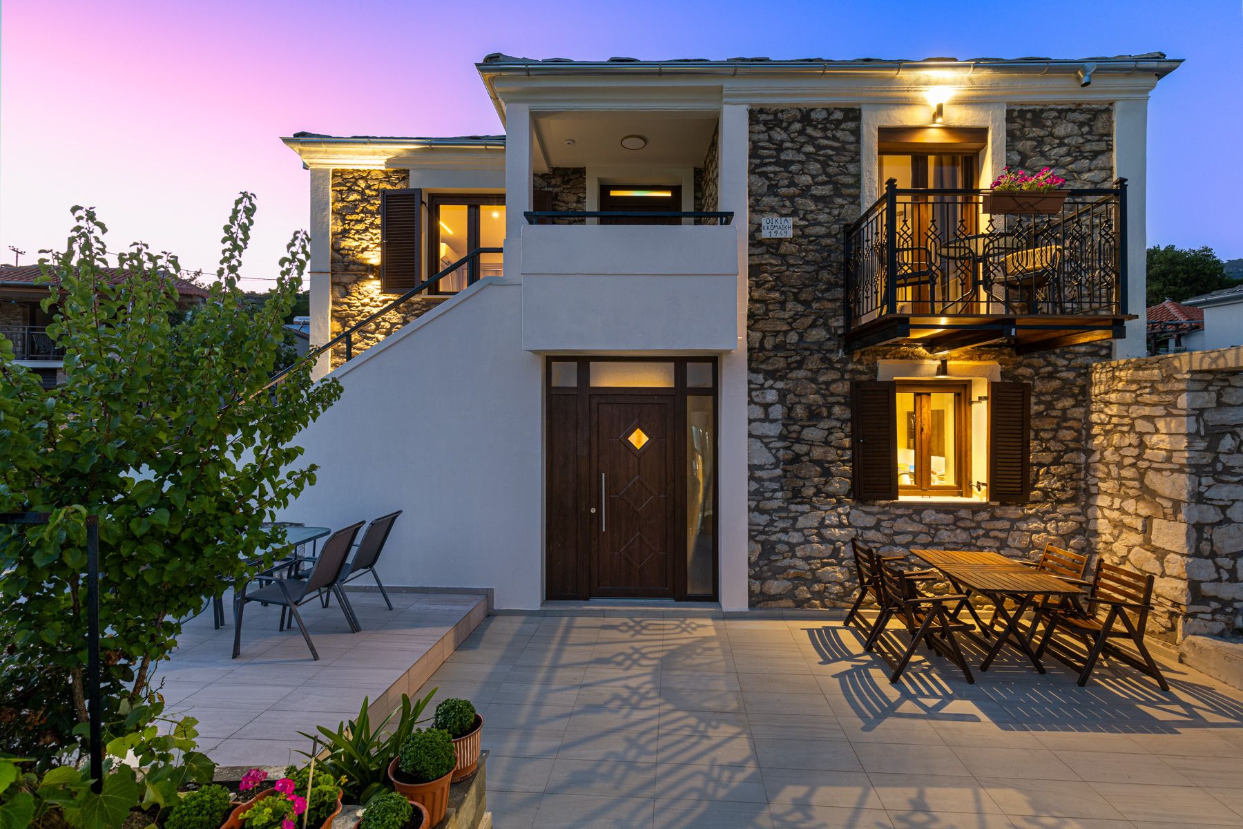 The entrance and the terrace dining table in the evening